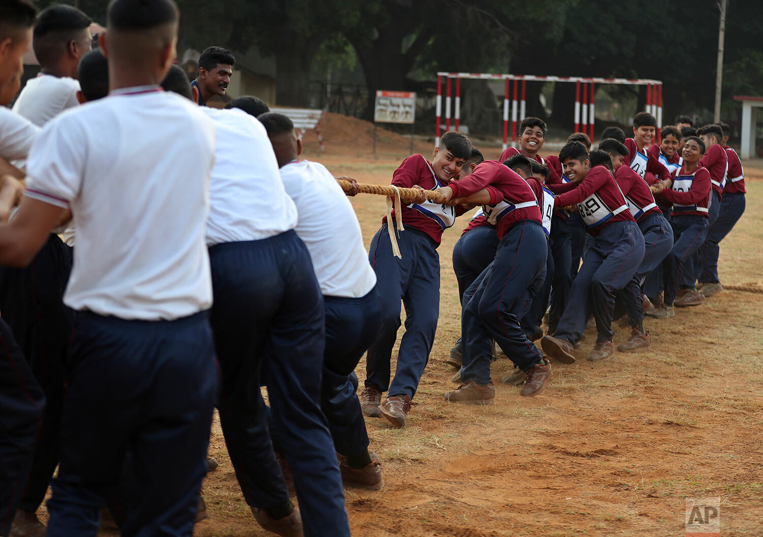 Indian army women recruits, right, pull the rope as they compete with men in tug of war as part of their training during a media visit in Bengaluru, India, Wednesday, March 31, 2021.  (AP Photo/Aijaz Rahi) 