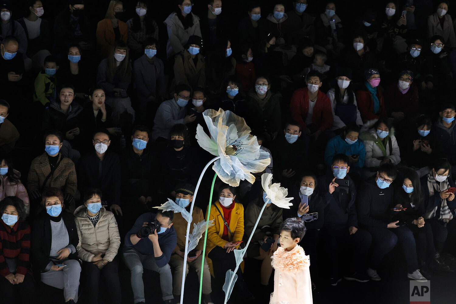  Attendees wear masks during a children's fashion show in Beijing on Sunday, March 28, 2021. (AP Photo/Ng Han Guan) 
