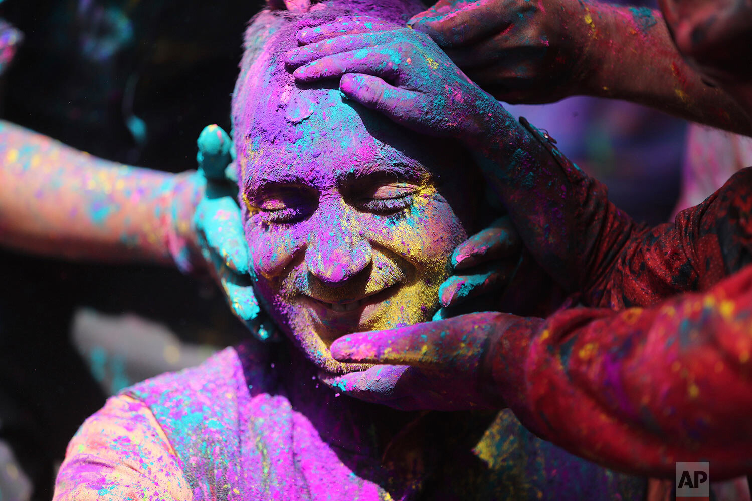  Indians smear colored powder on each other as they celebrate Holi in Jammu, India, Sunday, March 28, 2021. Holi, the Hindu festival of colors, also heralds the arrival of spring. (AP Photo/Channi Anand) 