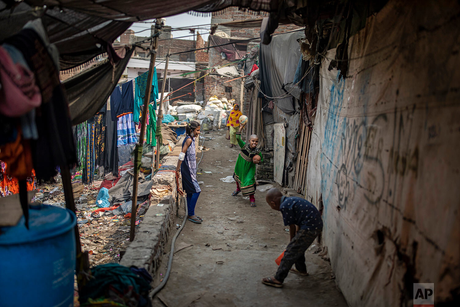  Children of migrant waste pickers play in a slum in New Delhi, India, Wednesday, March 10, 2021. (AP Photo/Altaf Qadri) 