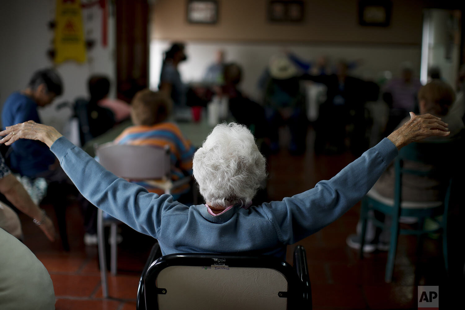  Delia Solbach attends an exercise class at the Reminiscencias residence for the elderly in Tandil, Argentina, Monday, April 5, 2021. (AP Photo/Natacha Pisarenko) 
