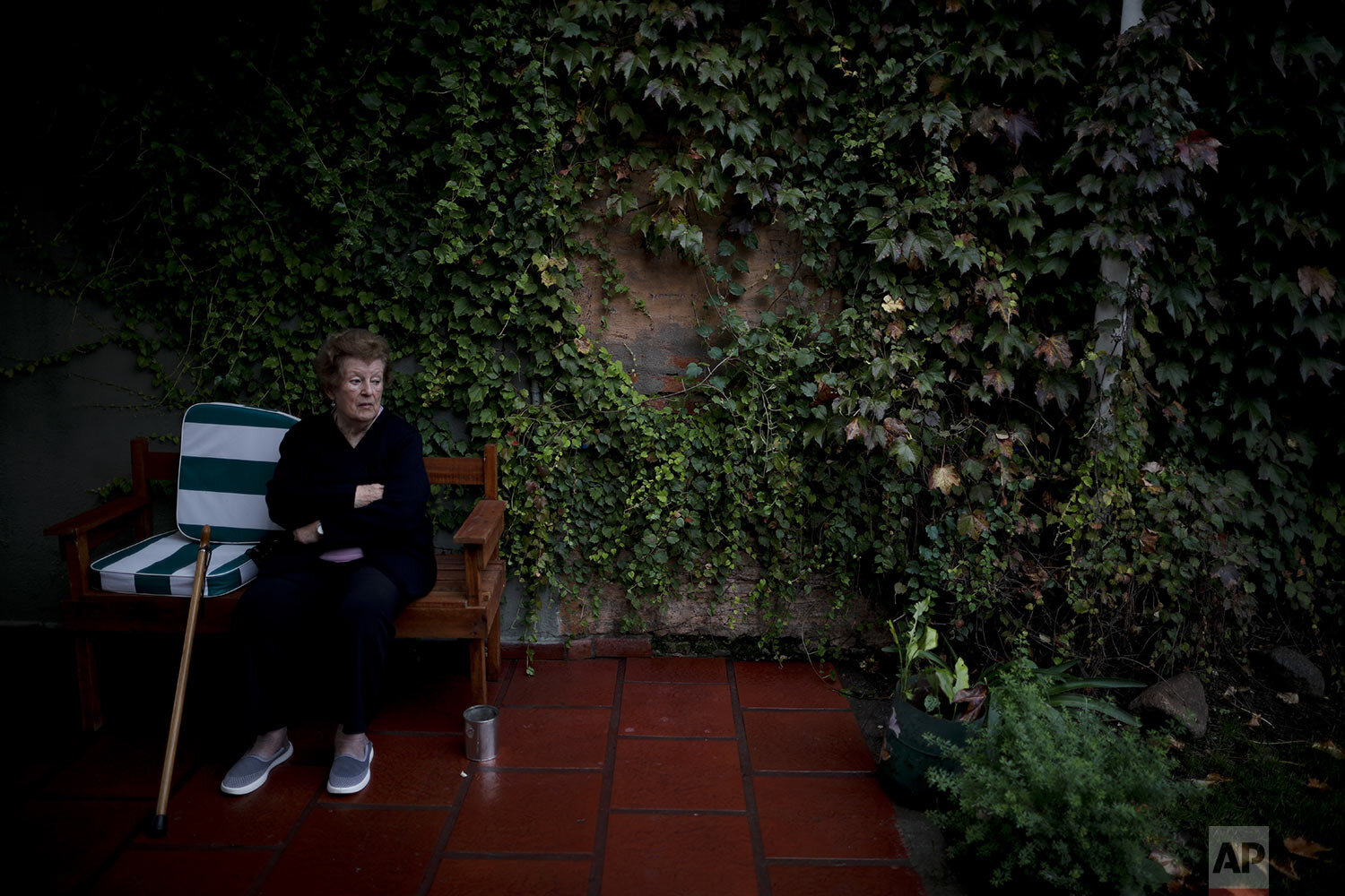  Thelma Amezua sits in the garden at the Reminiscencias residence for the elderly in Tandil, Argentina, Monday, April 5, 2021. (AP Photo/Natacha Pisarenko) 