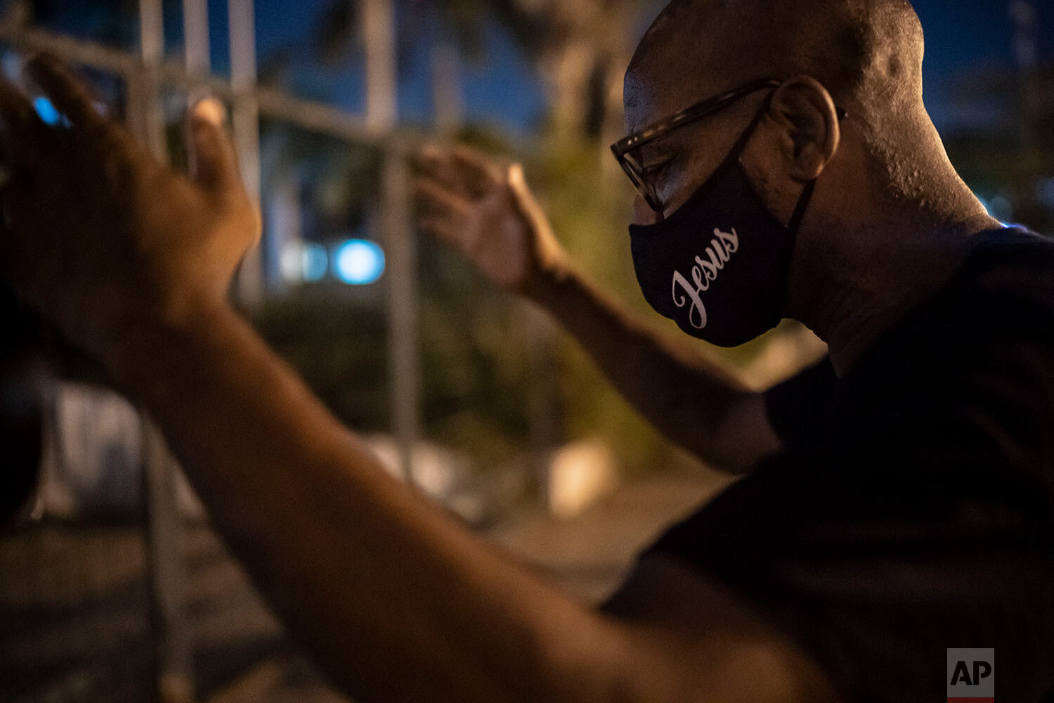  A member of the God's Love Evangelical Church and Rehab Center prays for COVID-19 patients outside a hospital in Rio de Janeiro, Brazil, Friday, March 26, 2021. (AP Photo/Felipe Dana) 