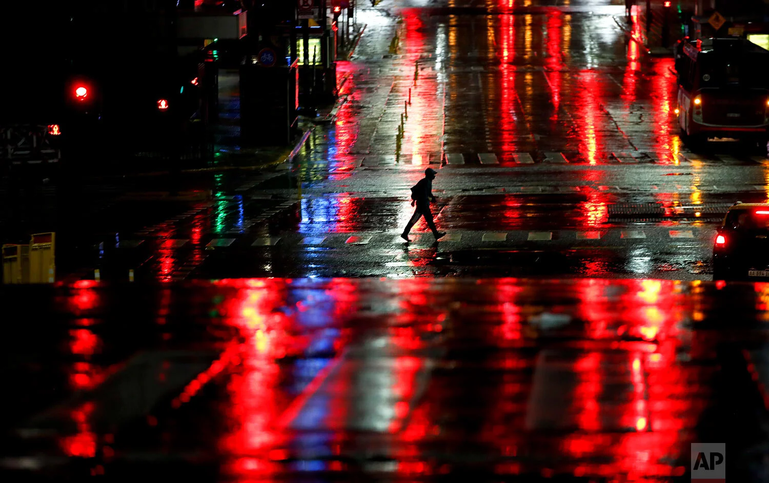 A man crosses Corrientes Avenue in Buenos Aires, Argentina, early Friday, April 9, 2021. Argentina has issued a nighttime lockdown that started at midnight Thursday night to try to stop the increase of COVID-19 infections. (AP Photo/Natacha Pisarenk