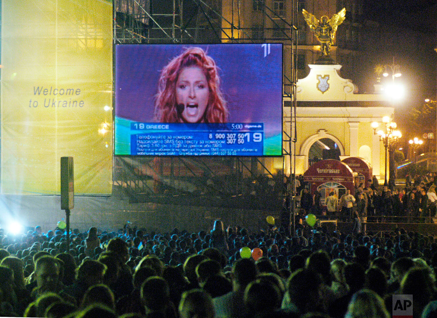 Ukrainians watch winner of the contest Helena Paparizou of Greece  performing during the finale of the Eurovision song contest on a giant screen in downtown Kiev, Saturday, May 21, 2005. (AP Photo/Sergei Chuzavkov) 