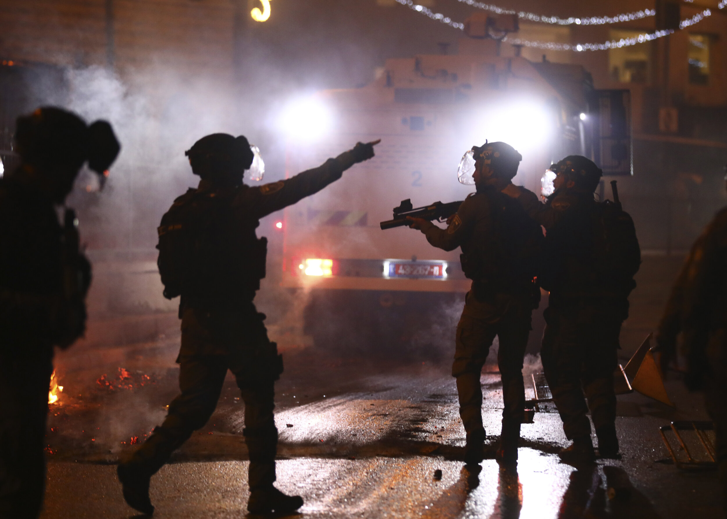  Israeli police officers fire stun grenades toward Palestinian demonstrators during clashes at Damascus Gate just outside Jerusalem's Old City, Saturday, May 8, 2021. (AP Photo/Oded Balilty) 