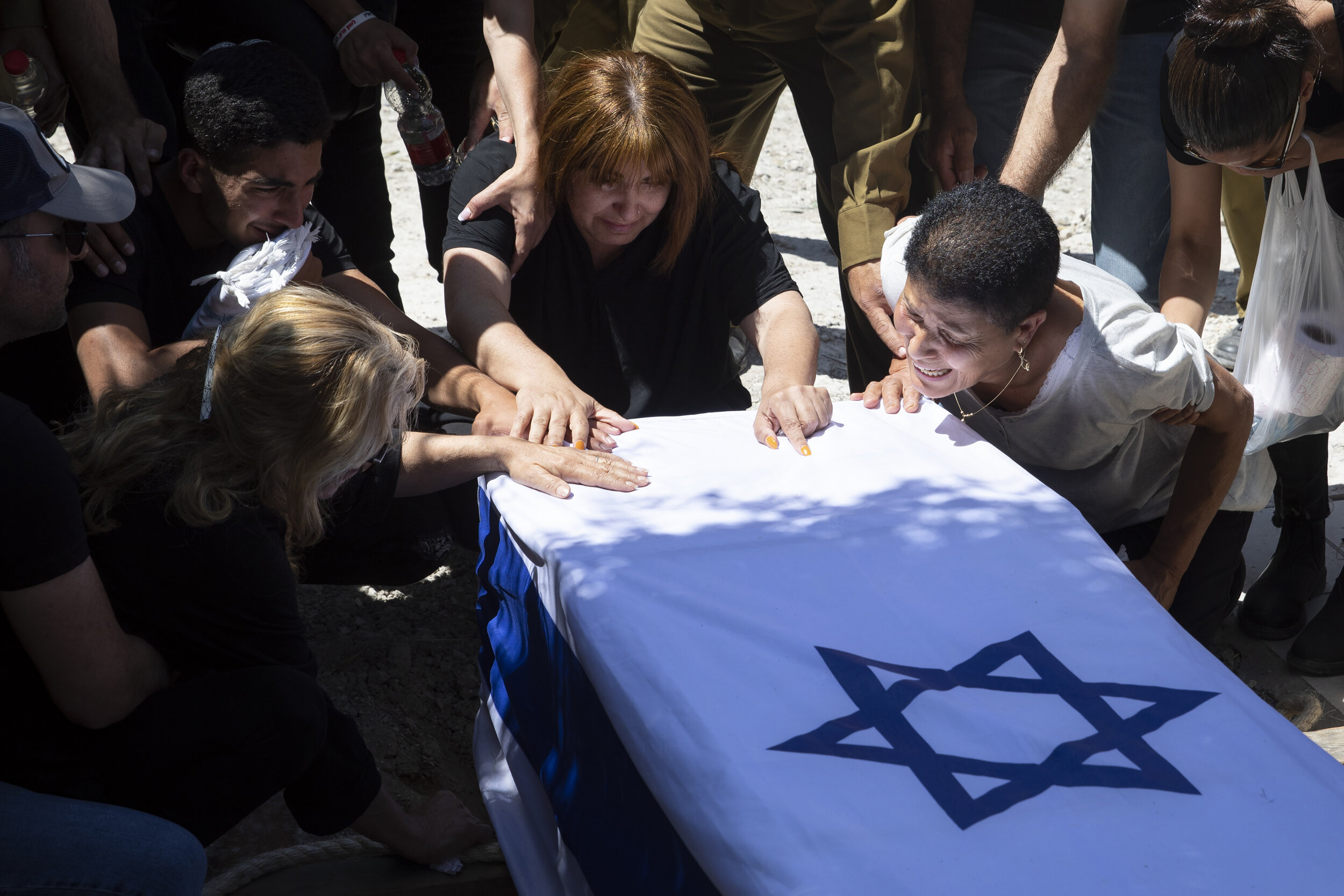  Relatives of Israeli soldier Omer Tabib, 21, mourn during his funeral at the cemetery in the northern Israeli town of Elyakim, Thursday, May 13, 2021. The Israeli army confirmed that Tabib was killed in an anti-tank missile attack near the Gaza Stri
