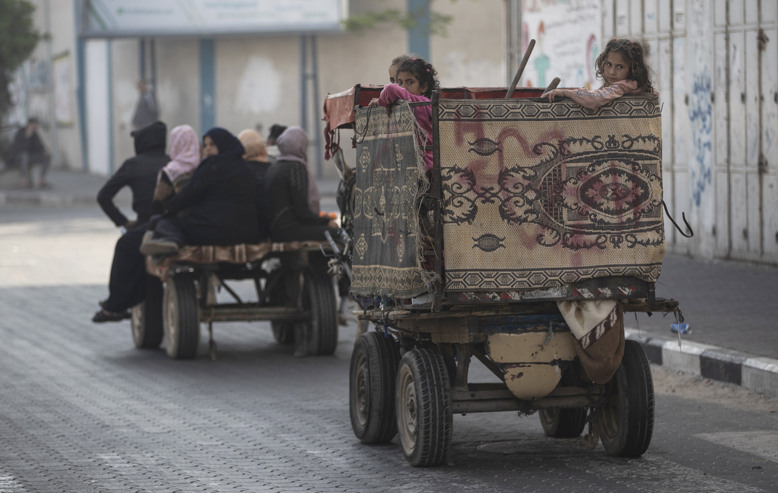  Palestinians flee their homes after overnight Israeli heavy missile strikes on their neighborhoods in the outskirts of Gaza City, Friday, May 14, 2021. (AP Photo/Khalil Hamra) 