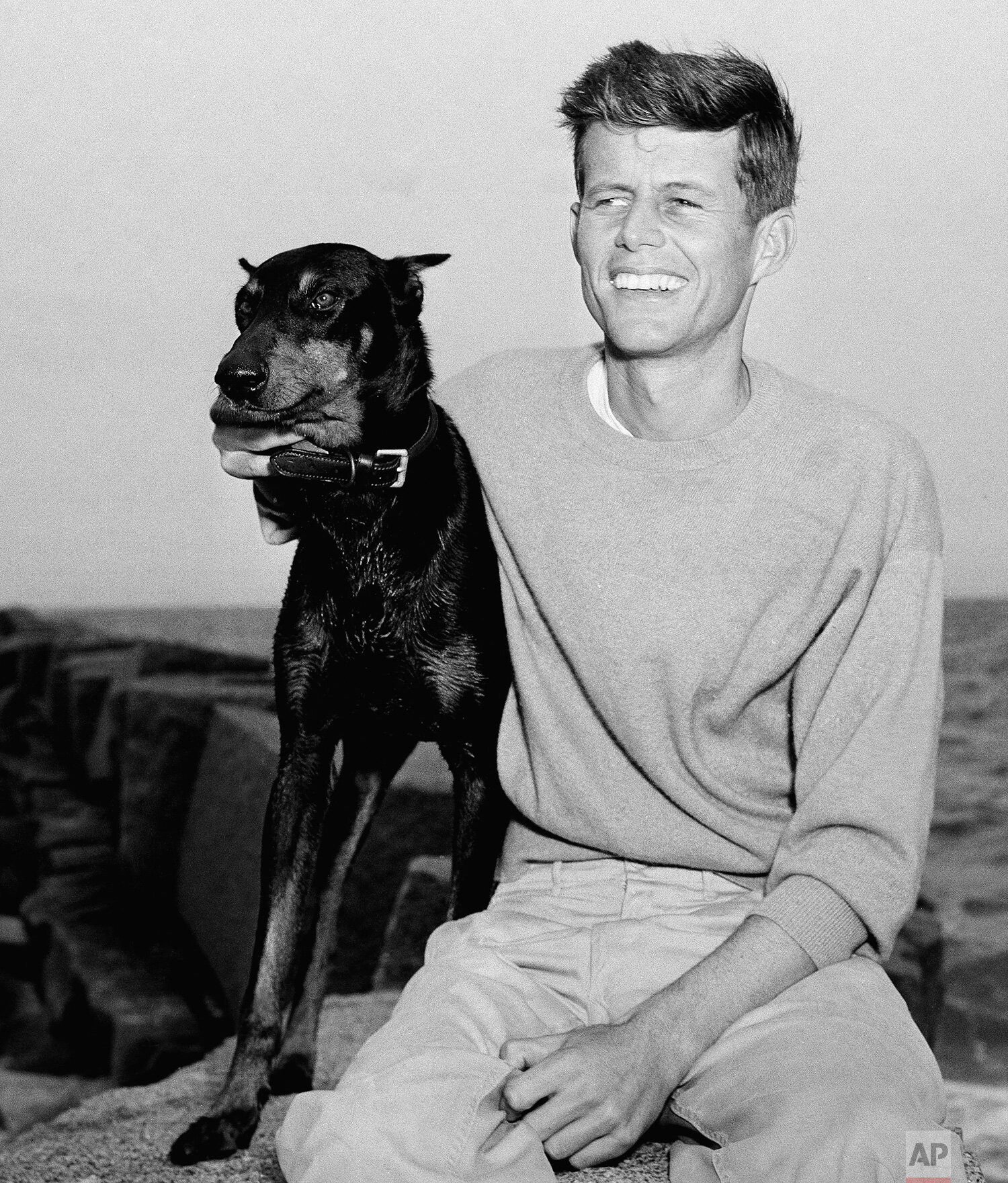  John F. Kennedy, winner of the Democratic Nomination for Congress in the 11th Massachusetts District, relaxes with his dog, Mo, in Hyannisport, Mass, June 22, 1946. (AP Photo/Peter J. Carroll) 