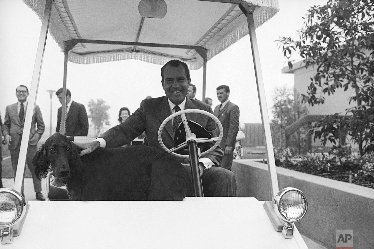  President Richard Nixon and his dog King Timahoe, arrive at the Western White House office in San Clemente after driving through a heavy fog in Nixon’s golf cart, Aug. 20, 1969.  (AP Photo) 