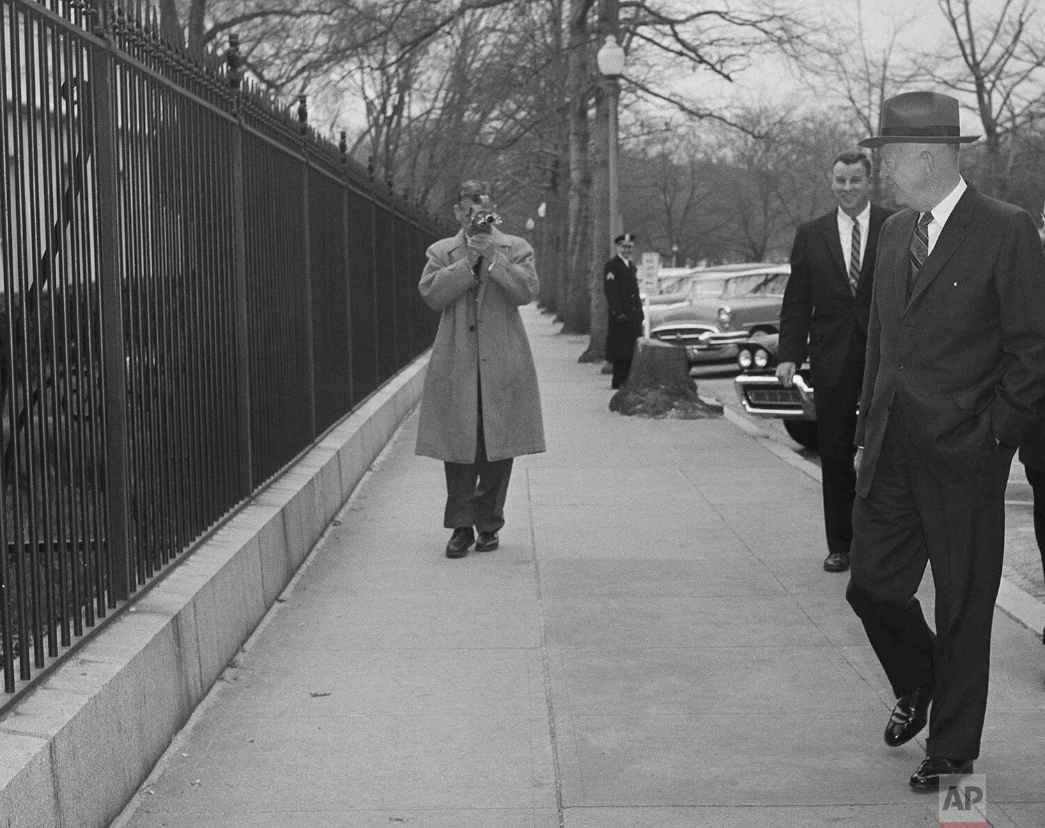  U.S. President Dwight Eisenhower has a greeting for his dog Heidi, a weimaraner, as she pokes her nose through the White House grounds fence in Washington, March 11, 1959. (AP Photo) 