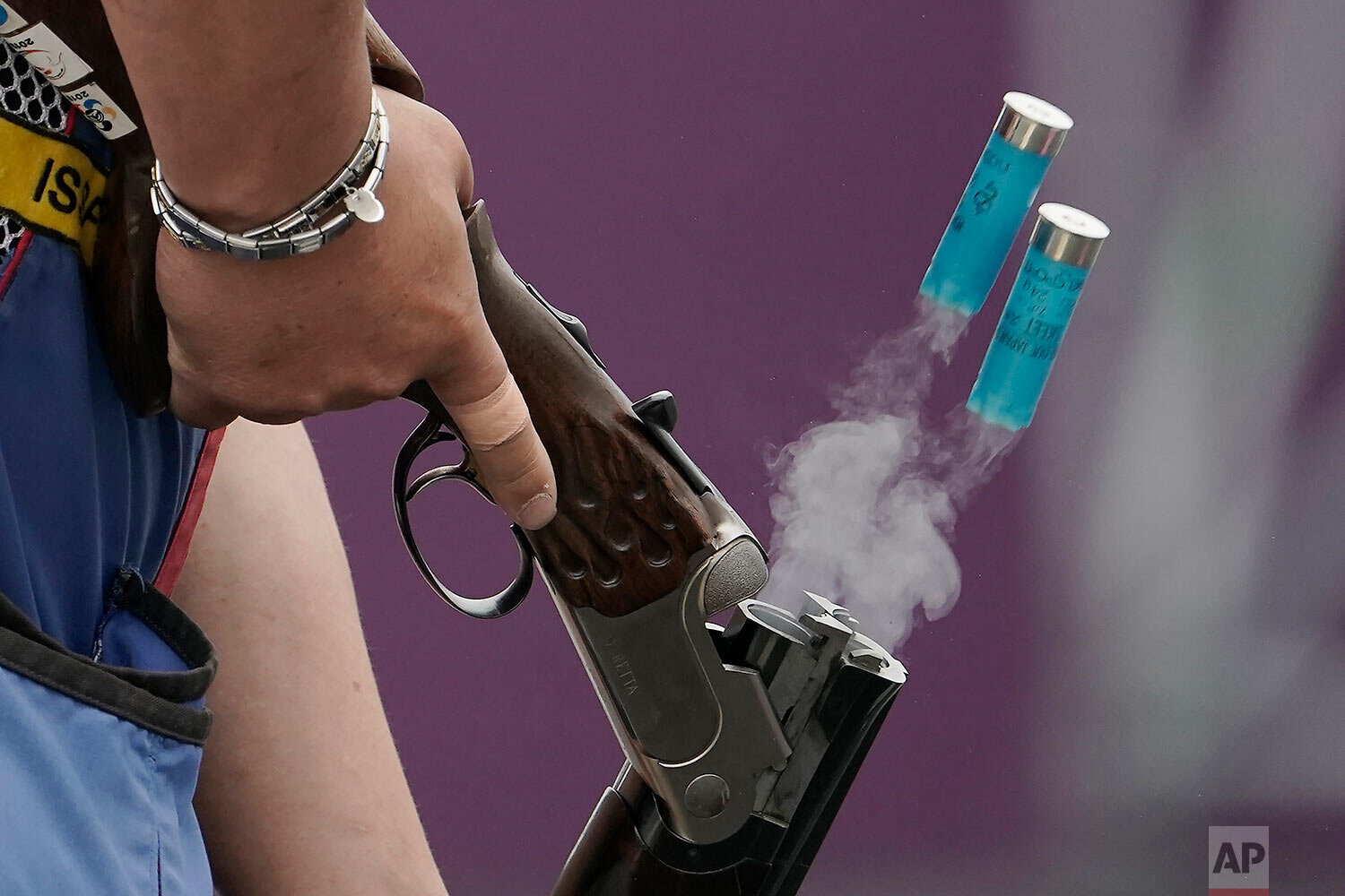  A local athlete ejects spent cartridge shells as he competes in the skeet shooting competition of the Tokyo 2020 Olympic Game Shooting test event Tuesday, May 18, 2021 at Asaka Shooting Range in Tokyo. (AP Photo/Eugene Hoshiko) 