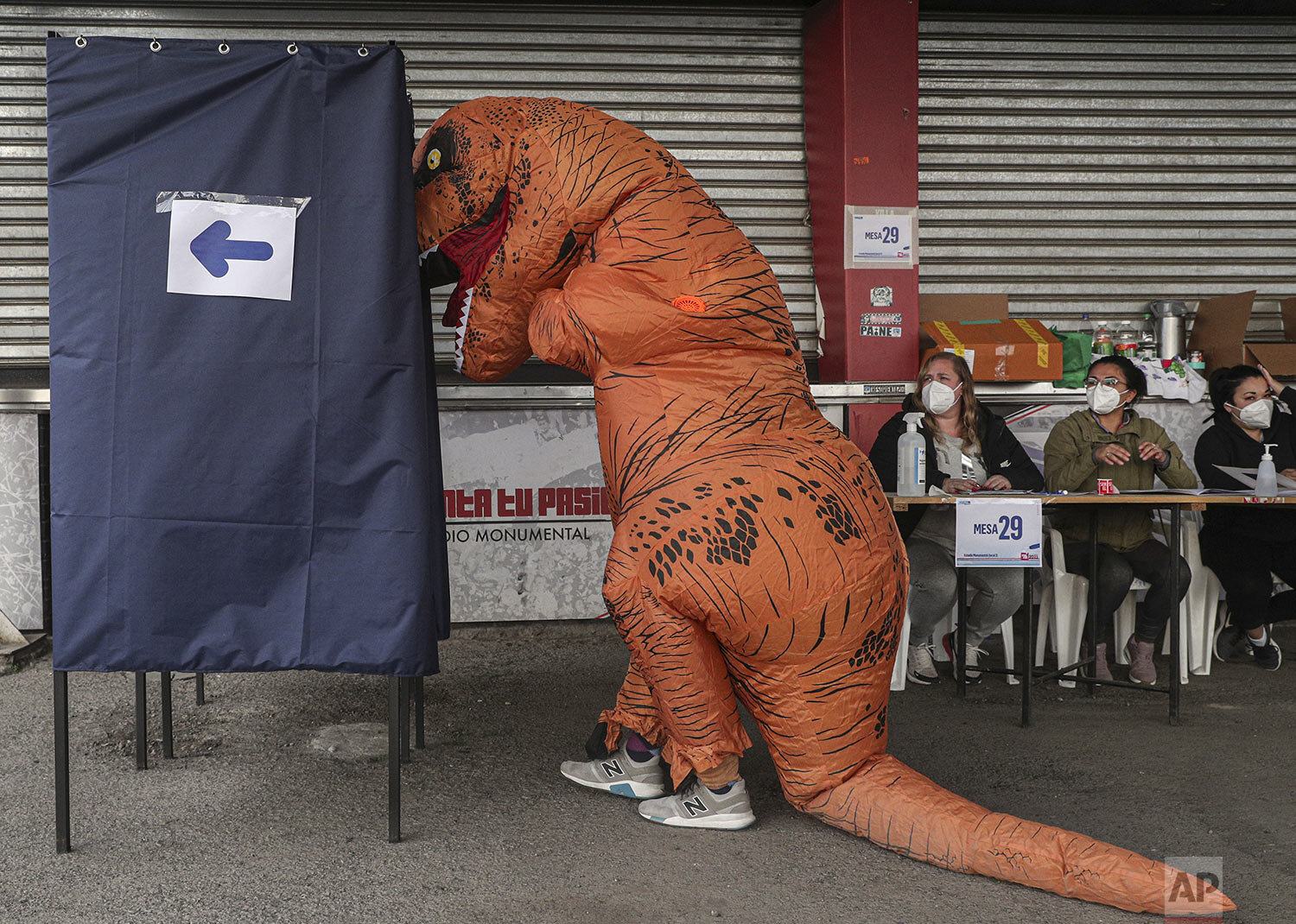  A person in a dinosaur costume votes on the second day of the Constitutional Convention election to select assembly members that will draft a new constitution in Santiago, Chile, May 16, 2021. (AP Photo/Esteban Felix) 