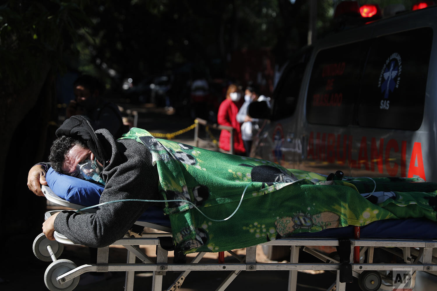  COVID-19 patient Eustaquio Ruiz lies on a stretcher outside the ICU of the Ineram Hospital, the fourth clinic where he was taken in search of a hospital with room in Asuncion, Paraguay, May 24, 2021. The 46-year-old was put back into the ambulance t