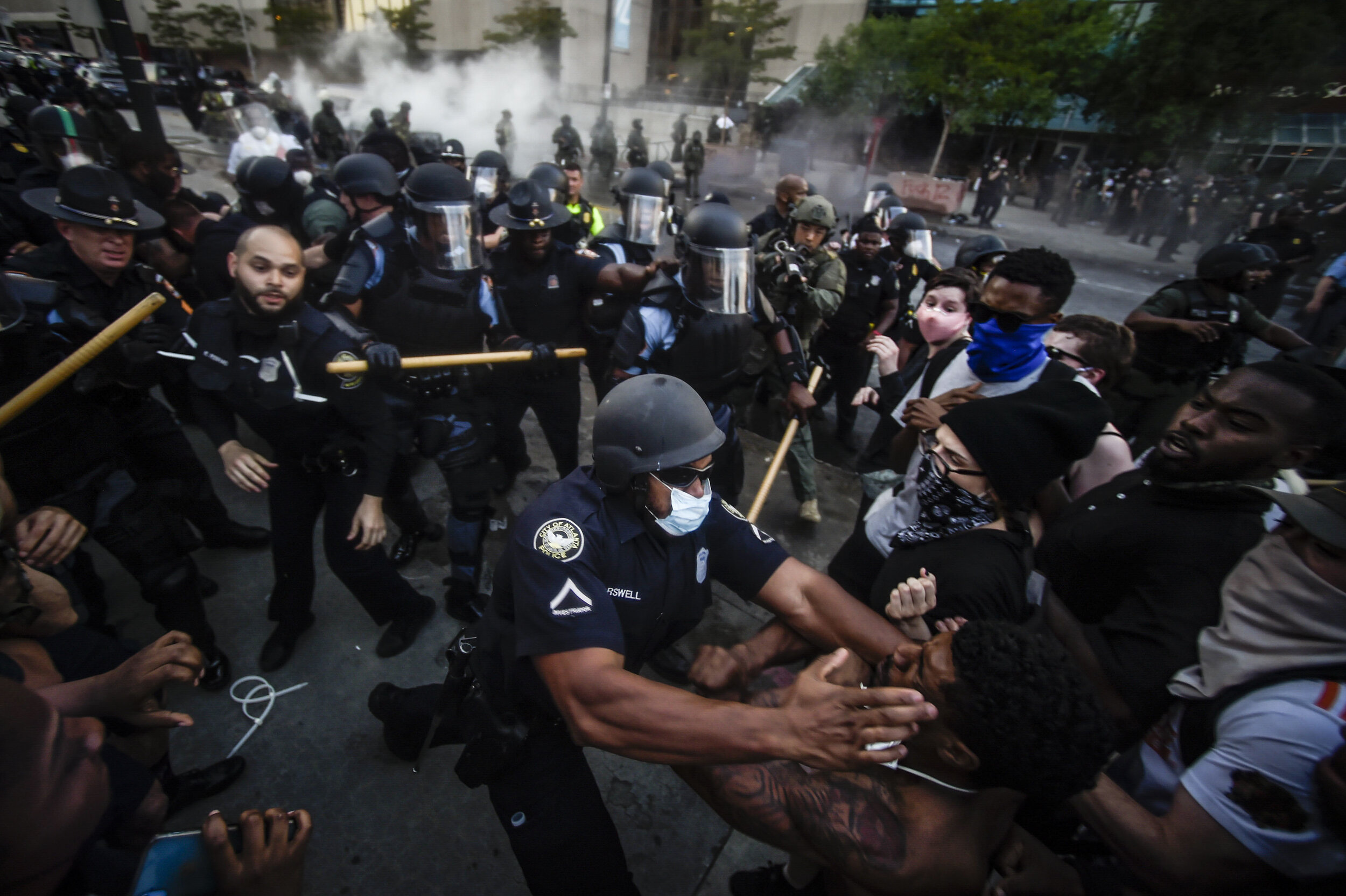  Police officers and protesters clash near CNN Center, May 29, 2020, in Atlanta, in response to George Floyd's death. The protest started peacefully earlier in the day before demonstrators clashed with police. (AP Photo/Mike Stewart) 
