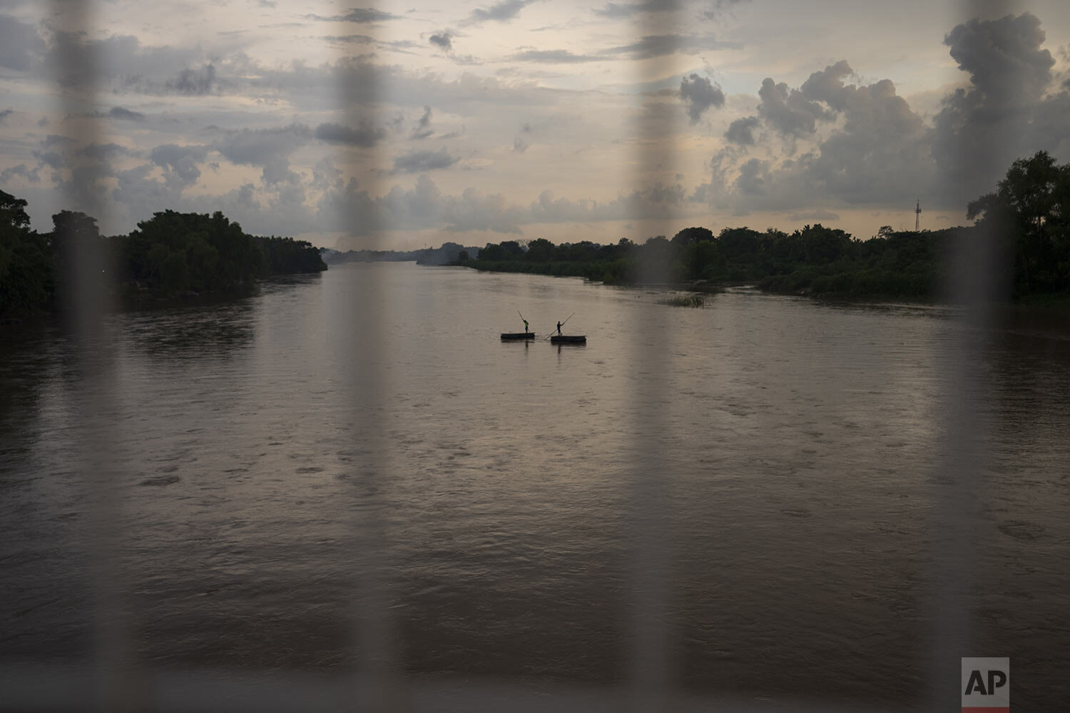  Rafts carry passengers across the Suchiate River between Tecun Uman, Guatemala, right, and Ciudad Hidalgo, Mexico, June 6, 2021. (AP Photo/Moises Castillo) 