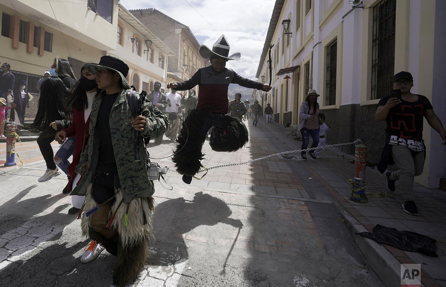  Revelers dance during the "Inti Raymi," or Sun Festival celebrations, despite restrictions to prevent the spread of the new coronavirus, in Cotacachi, Ecuador, June 24, 2021. Indigenous communities gather for the southern hemisphere's winter solstic