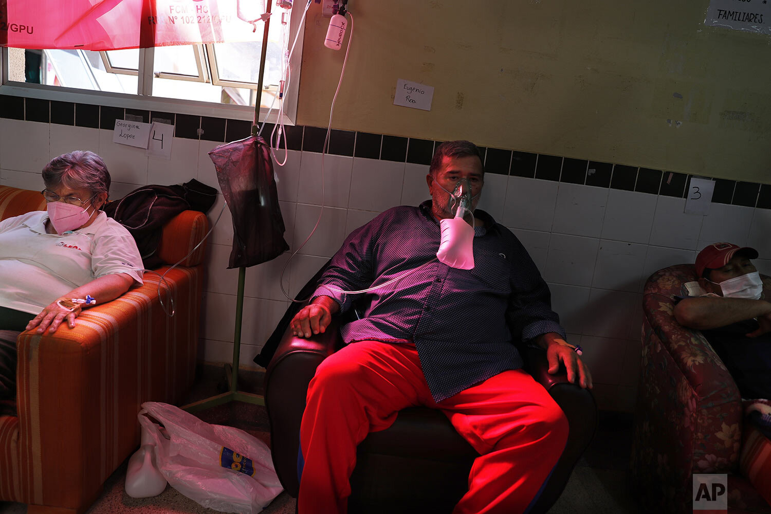  COVID-19 patients sit in armchairs in a hospital hallway due to a lack of available beds at the Clinicas Hospital in San Lorenzo, Paraguay, June 4, 2021. (AP Photo/Jorge Saenz) 