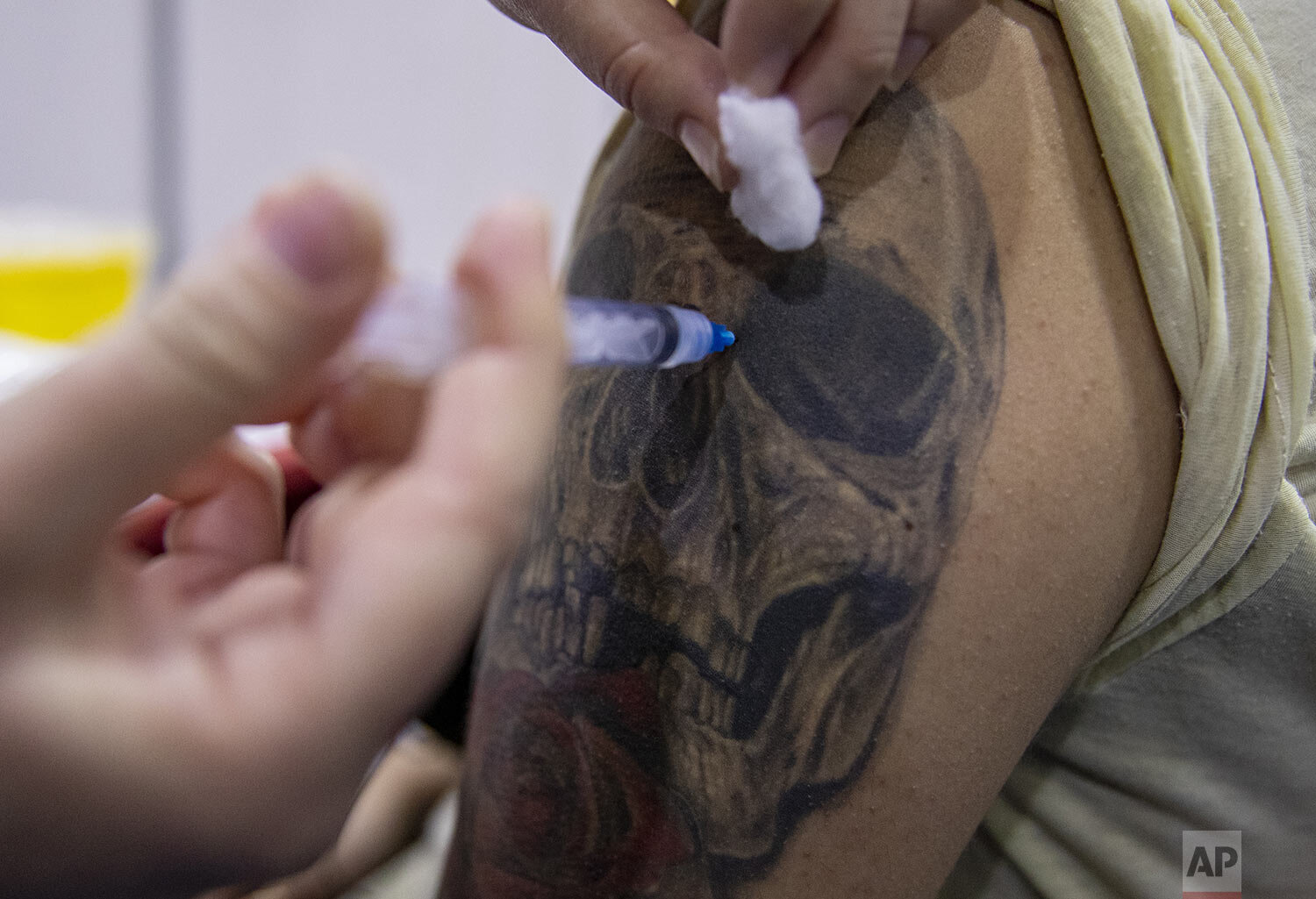 A healthcare worker injects a student with a dose of the CanSino COVID-19 vaccine on the Andres Bello University campus in Santiago, Chile, June 3, 2021. (AP Photo/Esteban Felix)
