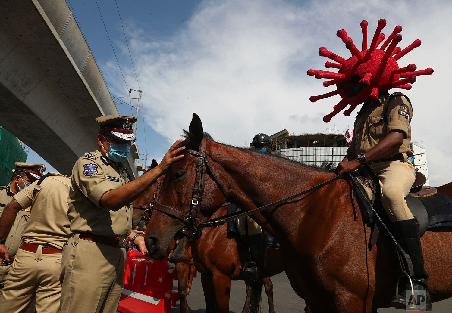  A policeman rides a horse wearing a virus-themed helmet during a COVID-19 awareness drive in Hyderabad, India, Tuesday, June 1, 2021. (AP Photo/Mahesh Kumar A.) 