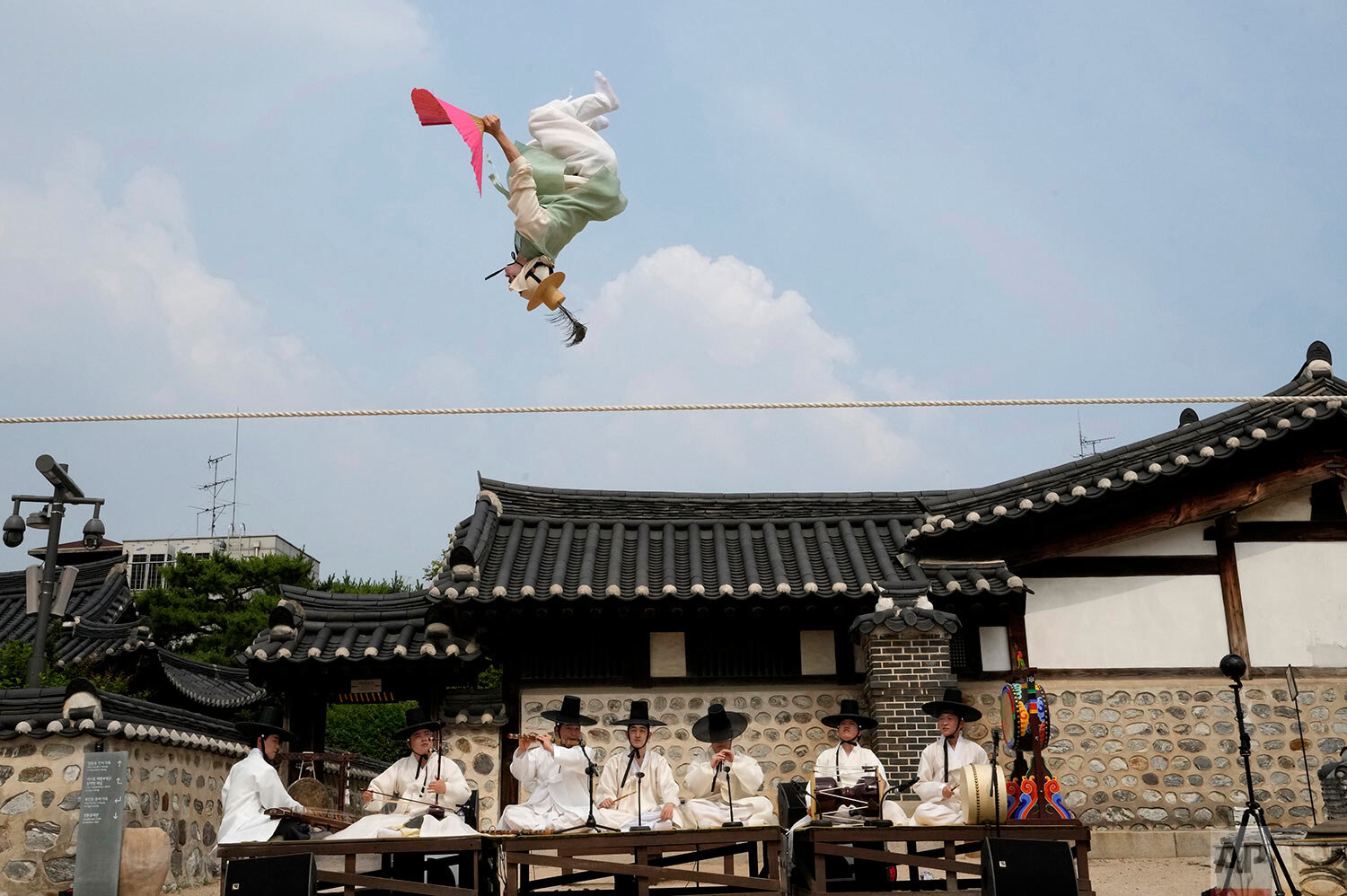  Nam Chang-dong, a South Korean tightrope walker, performs "Jultagi," or Tightrope Walking, at the Namsan Hanok village in Seoul, South Korea, Monday, June 14, 2021. (AP Photo/Ahn Young-joon) 