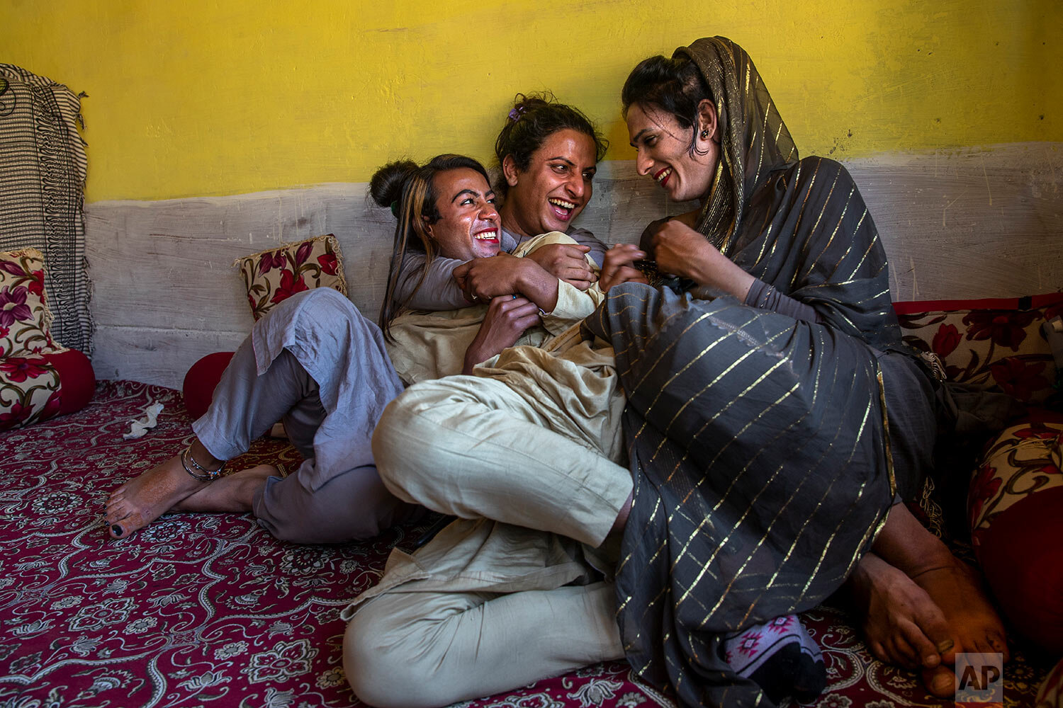  Khushi Mir, left, a transgender Kashmiri, relaxes with friends at the end of a meeting of community members in the outskirts of Srinagar, Indian controlled Kashmir, Friday, June 4, 2021. (AP Photo/ Dar Yasin) 
