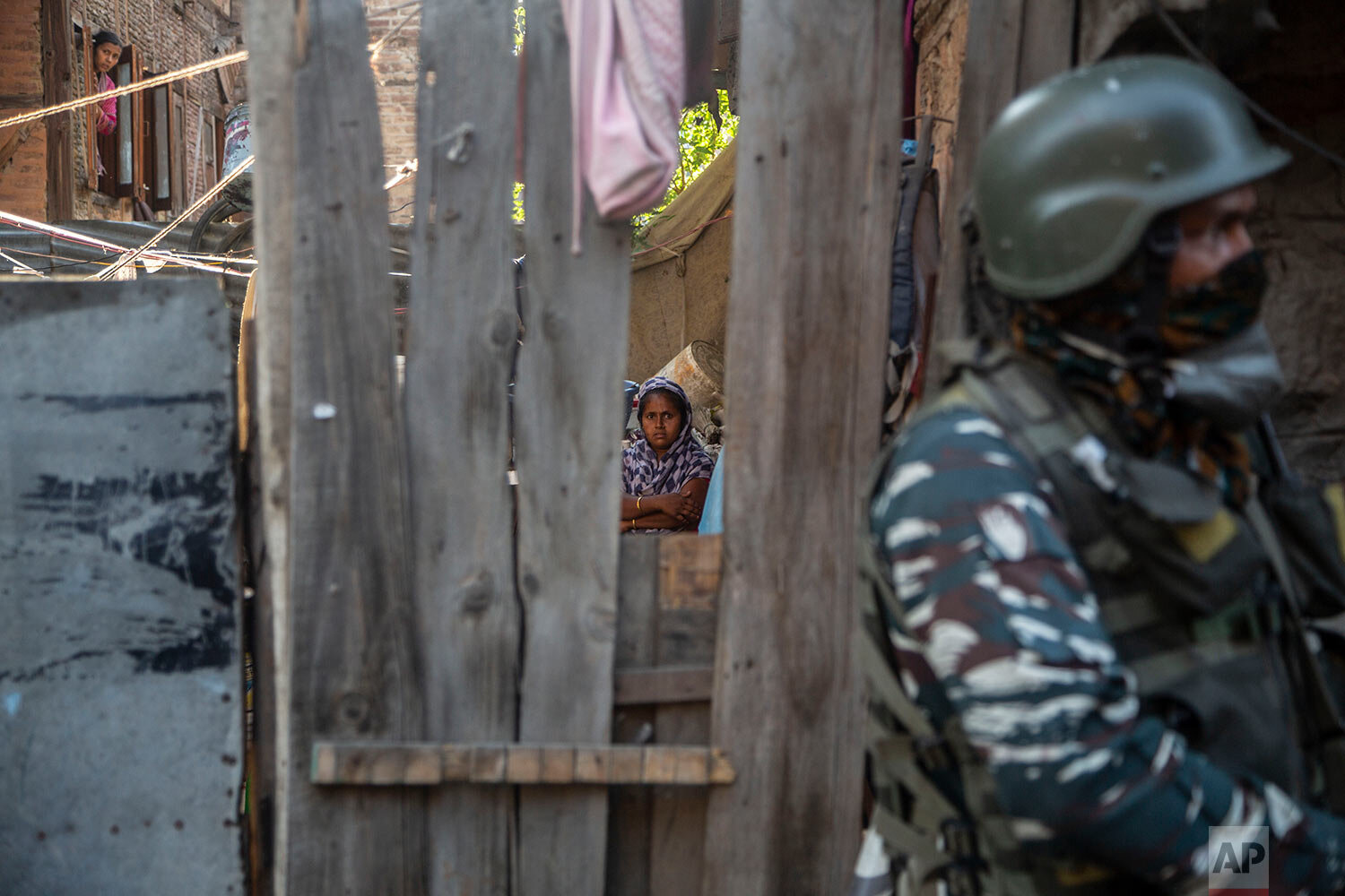  An Indian soldier keeps guard near the site of a grenade attack on a security force post in Srinagar, Indian controlled Kashmir, Sunday, June 26, 2021. (AP Photo/Mukhtar Khan) 