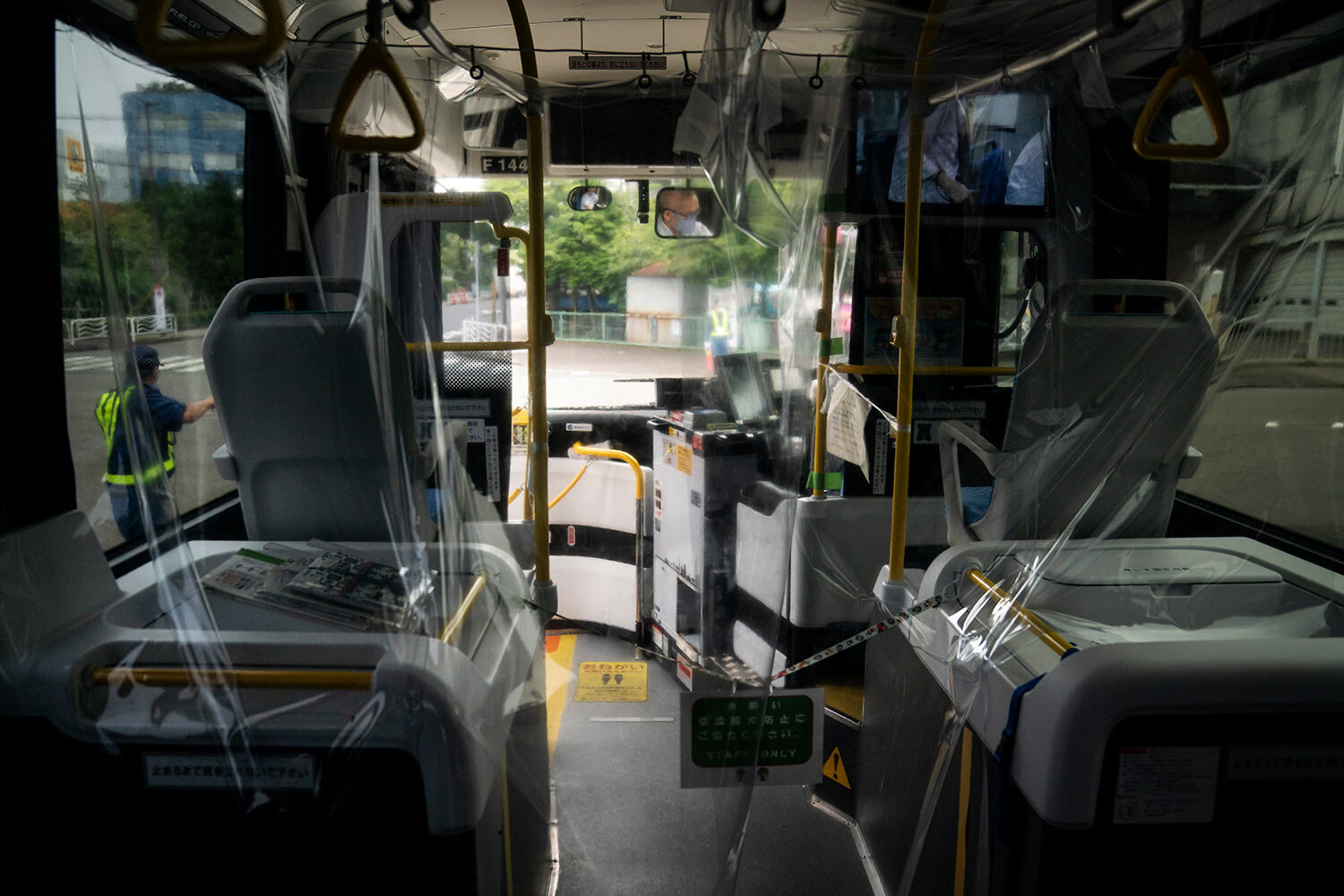  A protective plastic cover is installed in a shuttle bus to help curb the spread of COVID-19 prior to the 2020 Summer Olympics Sunday, July 11, 2021, in Tokyo. (AP Photo/Jae C. Hong) 