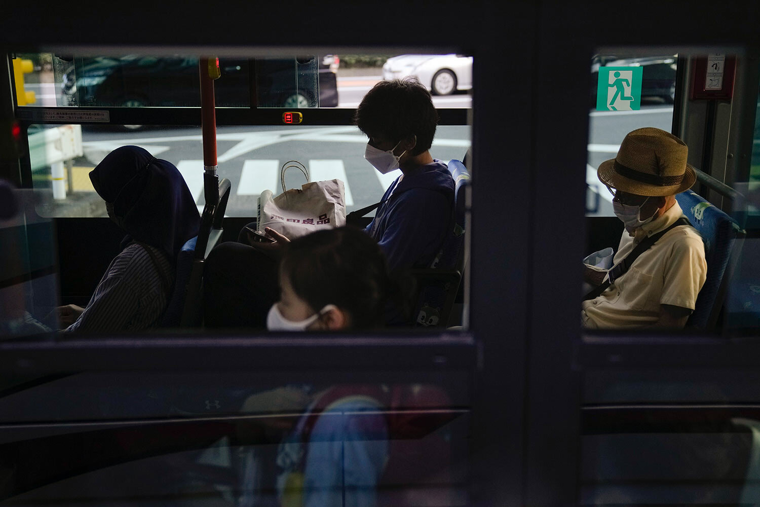  Commuters sit in a bus ahead of the 2020 Summer Olympics, Friday, July 16, 2021, in Tokyo. (AP Photo/Jae C. Hong) 