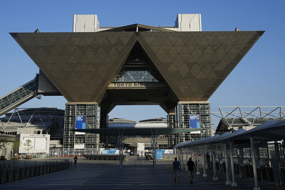  People walk outside the Tokyo Big Sight that houses the International Broadcast Center and Main Press Center in Tokyo, Monday, July 19, 2021. (AP Photo/Natacha Pisarenko) 