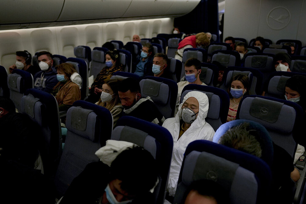  Passengers sit on a flight from Buenos Aires to Frankfurt, Germany, Saturday, July 17, 2021. (AP Photo/Natacha Pisarenko) 