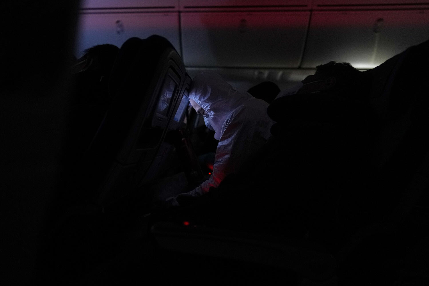 A passenger sleeps on a flight from Buenos Aires to Frankfurt, Germany, Sunday, July 18, 2021. (AP Photo/Natacha Pisarenko) 