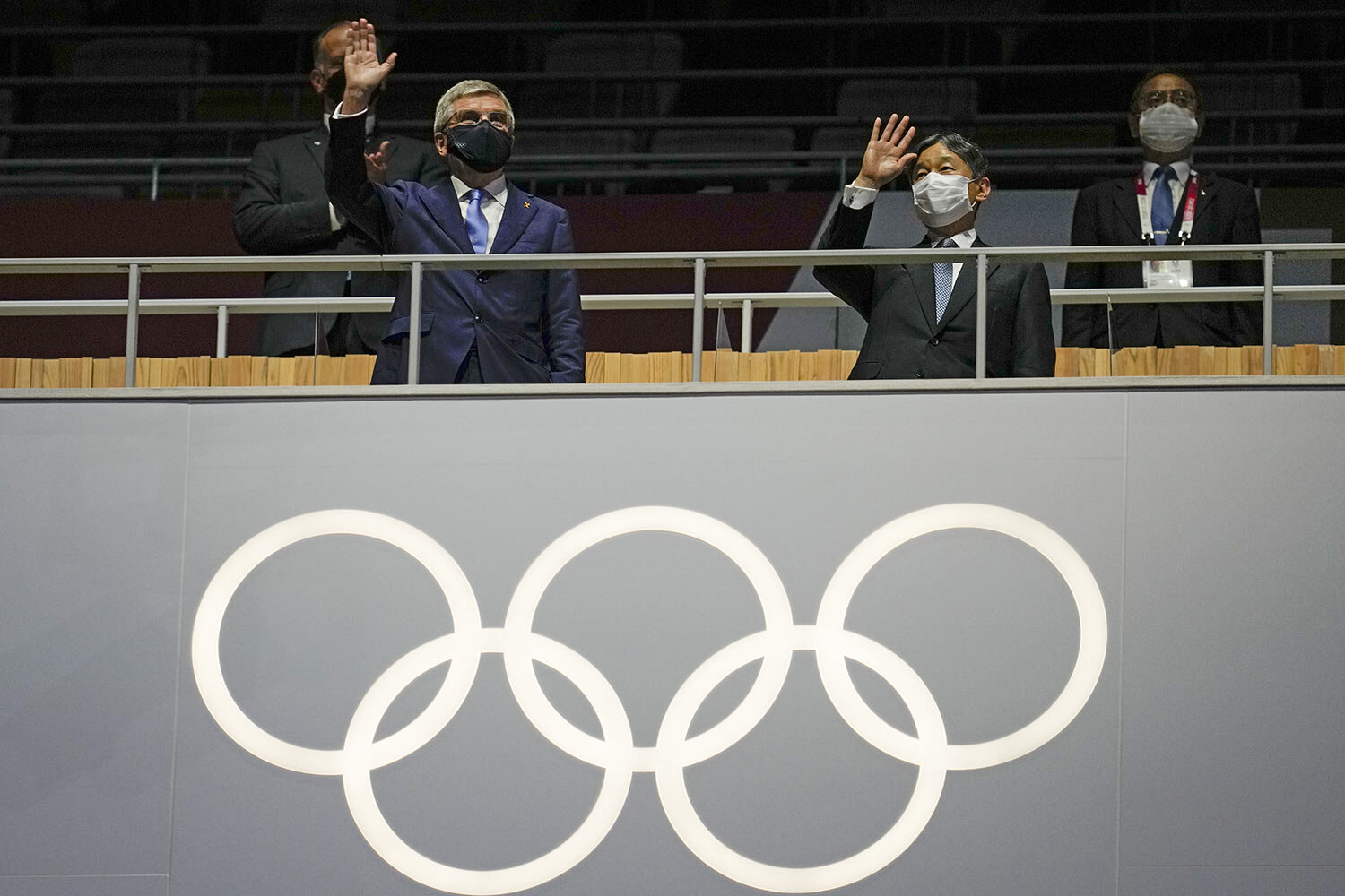  President of the IOC Thomas Bach, left, and Japan's Emperor Naruhito wave during the opening ceremony in the Olympic Stadium at the 2020 Summer Olympics, Friday, July 23, 2021, in Tokyo, Japan. (AP Photo/Natacha Pisarenko) 
