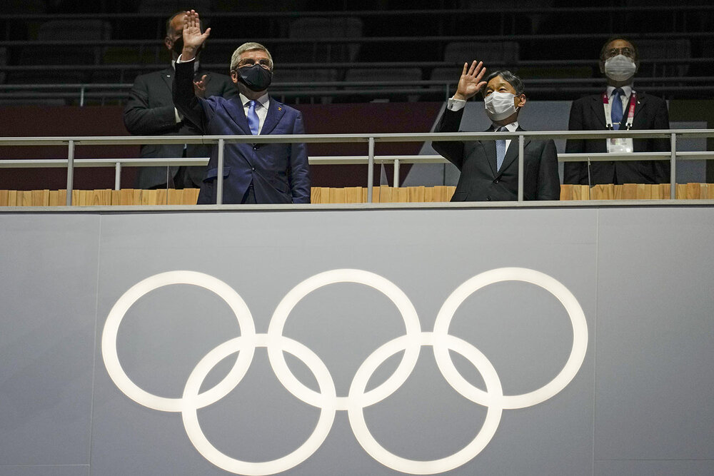  President of the IOC Thomas Bach, left, and Japan's Emperor Naruhito wave during the opening ceremony in the Olympic Stadium at the 2020 Summer Olympics, Friday, July 23, 2021, in Tokyo, Japan. (AP Photo/Natacha Pisarenko) 