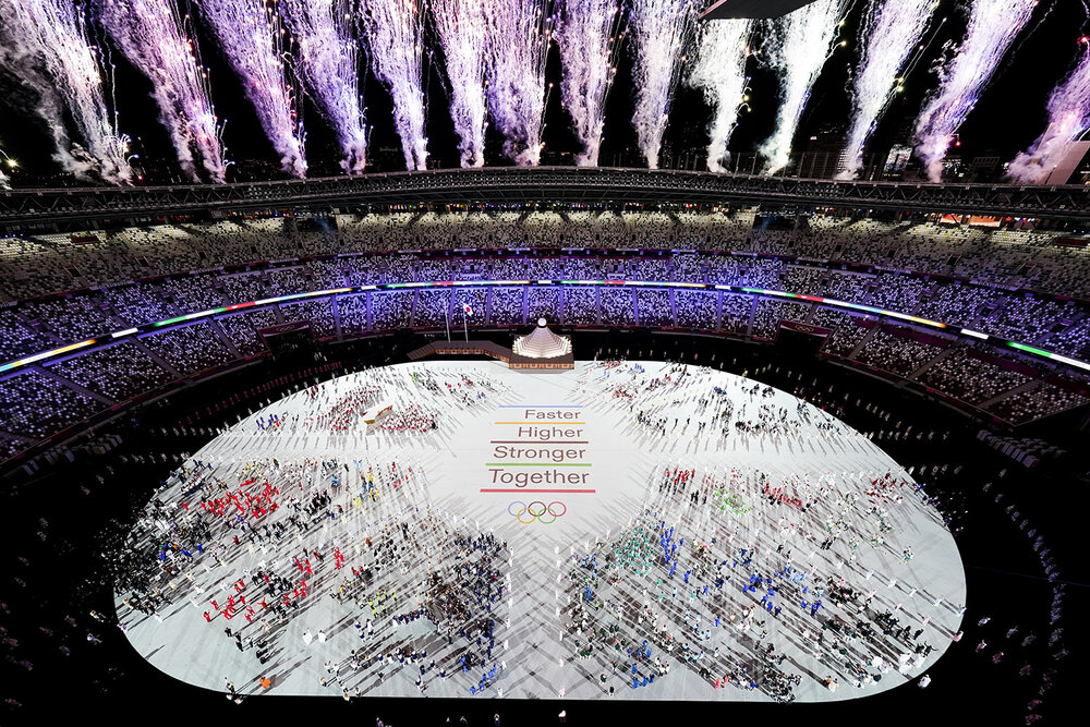  Athletes are seen with fireworks during the opening ceremony at the Olympic Stadium at the 2020 Summer Olympics, Friday, July 23, 2021, in Tokyo. (AP Photo/Morry Gash) 