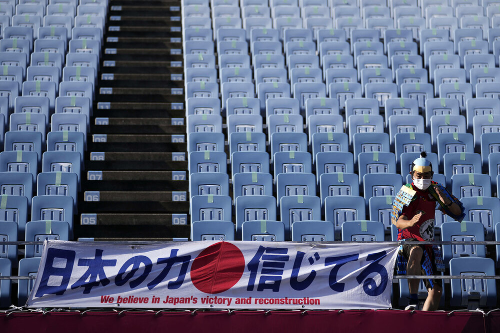  A fan poses for poses for a picture as he arrives at Miyagi Stadium for a women's soccer match at the 2020 Summer Olympics, Saturday, July 24, 2021, in Miyagi, Japan. (AP Photo/Andre Penner) 