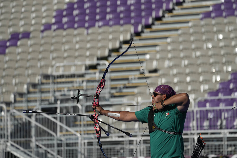  Backdropped by empty seat at Yumenoshima Park Archery Field Mexico's Luis Alvarez releases an arrow during the mixed team competition at the 2020 Summer Olympics, Saturday, July 24, 2021, in Tokyo, Japan. (AP Photo/Alessandra Tarantino) 