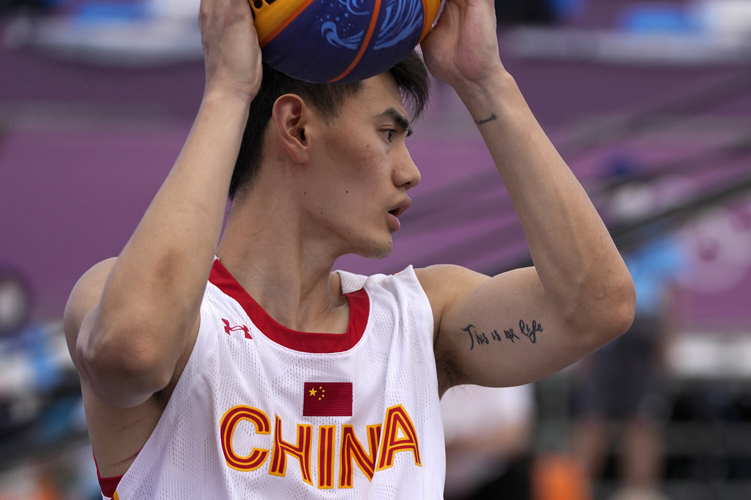  China's Yan Peng has a tattoo on his arm during a men's 3-on-3 basketball game against Latvia at the 2020 Summer Olympics, Sunday, July 25, 2021, in Tokyo, Japan. (AP Photo/Jeff Roberson) 