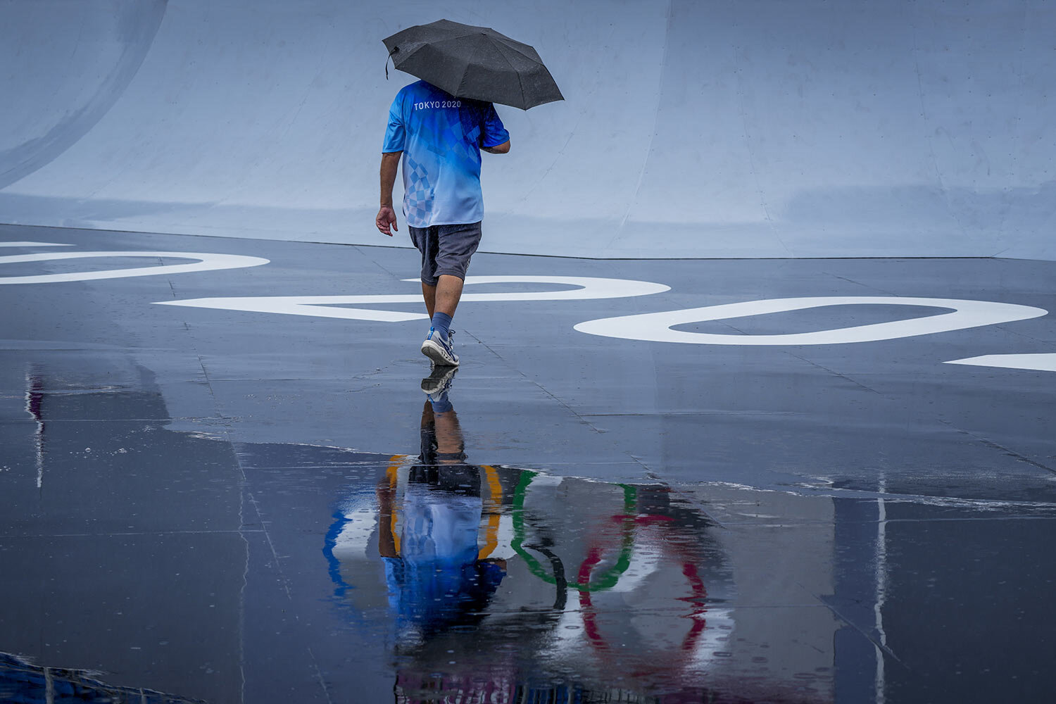  A venue official takes a look at the BMX Freestyle course after a training session was cancelled due to rain, at the 2020 Summer Olympics, Tuesday, July 27, 2021, in Tokyo, Japan. (AP Photo/Ben Curtis) 