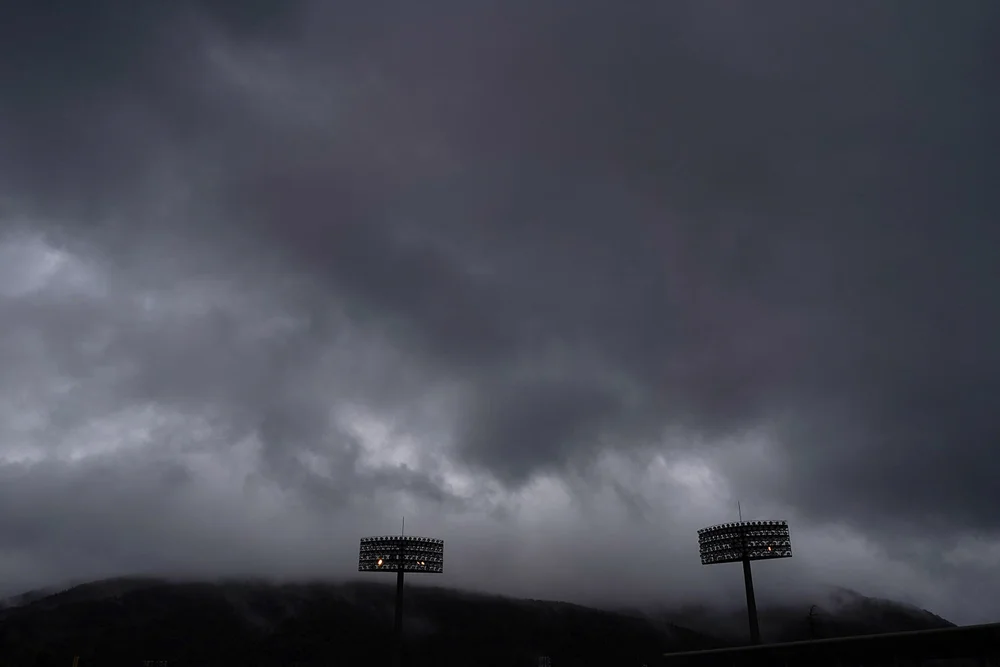  Storm clouds hover over the Fukushima Azuma Baseball Stadium at the 2020 Summer Olympics, Tuesday, July 27, 2021, in Fukushima, Japan. Japan opens the Olympic baseball tournament against the Dominican Republic Wednesday. (AP Photo/Jae C. Hong) 
