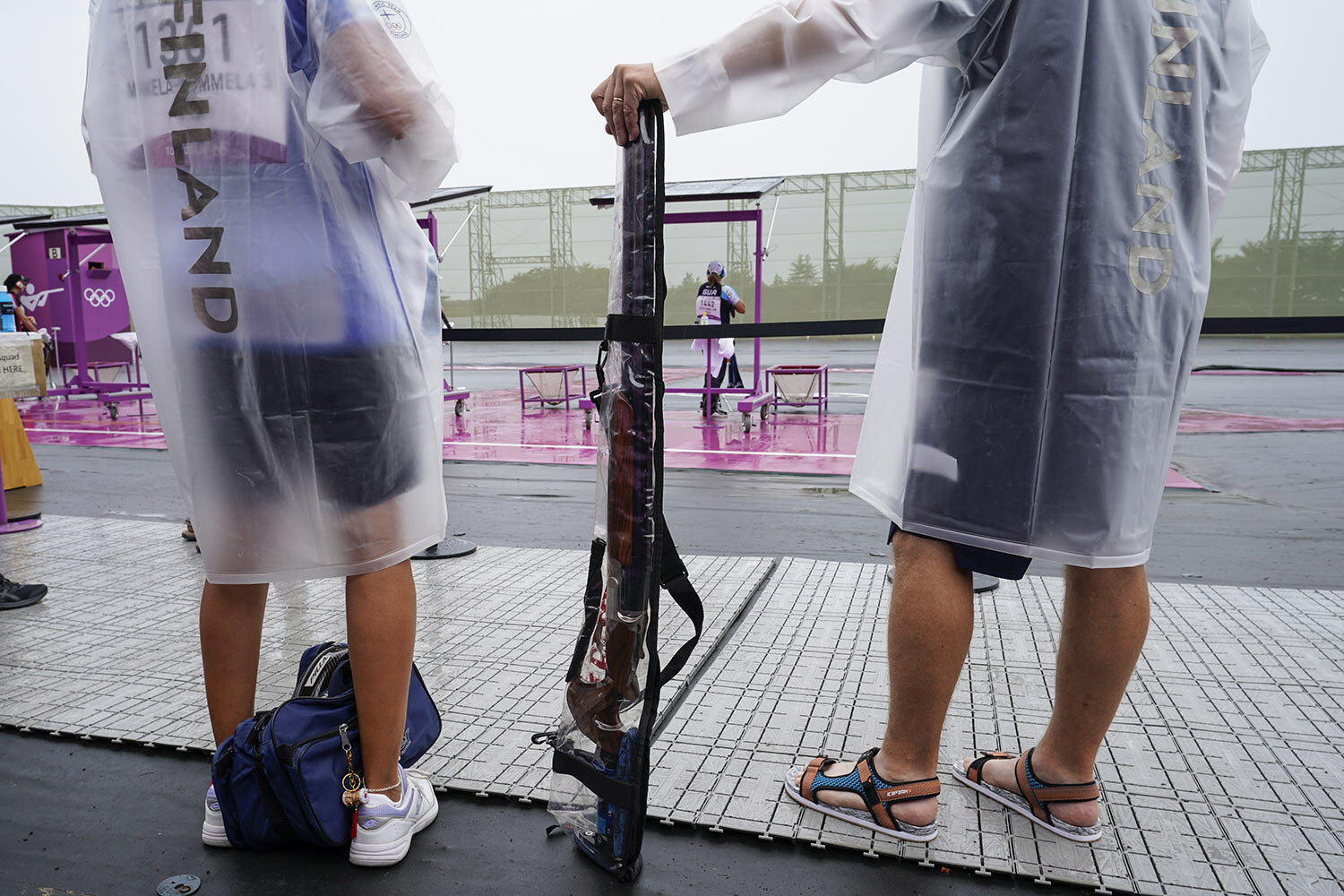  Satu Makela-Nummela, left, of Finland, with her coach, uses a protective rain cover for her shotgun before practice for the women's trap at the Asaka Shooting Range in the 2020 Summer Olympics, Tuesday, July 27, 2021, in Tokyo, Japan. (AP Photo/Alex