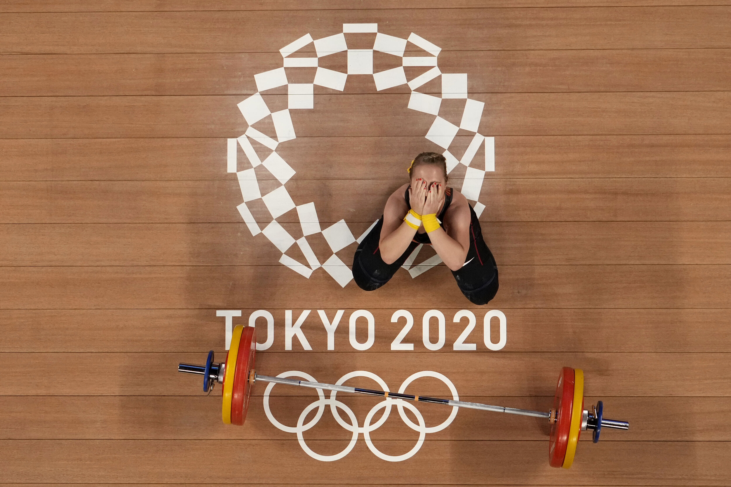  Sabine Beate Kusterer of Germany gestures after an unsuccessful lift during the women's 59kg weightlifting event, at the 2020 Summer Olympics, Tuesday, July 27, 2021, in Tokyo, Japan. (AP Photo/Luca Bruno) 