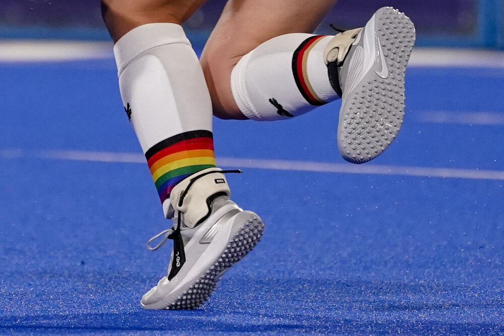  Germany's Nike Lorenz wears a rainbow emblazoned shin guard as she passes the ball during a women's field hockey match against India at the 2020 Summer Olympics, Monday, July 26, 2021, in Tokyo, Japan. (AP Photo/John Minchillo) 