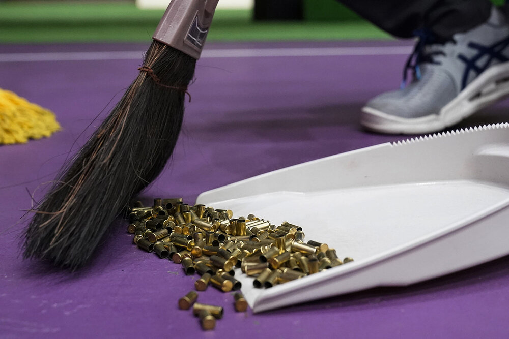  Empty .22 LR caliber shell casings are swept up after the women's 25-meter pistol at the Asaka Shooting Range in the 2020 Summer Olympics, Friday, July 30, 2021, in Tokyo, Japan. (AP Photo/Alex Brandon) 