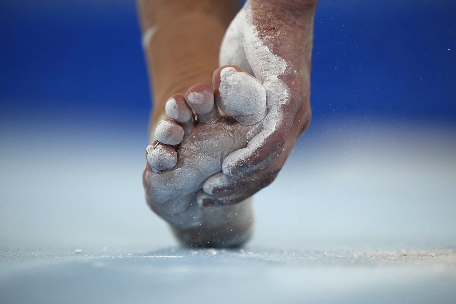  The Russian Olympic Committee's Artur Dalaloyan applies chalk before performing on the floor during the men's artistic gymnastic qualifications at the 2020 Summer Olympics, Saturday, July 24, 2021, in Tokyo. (AP Photo/Gregory Bull) 