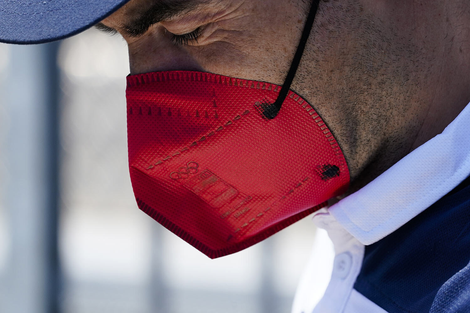  A member of the Spain men's field hockey team staff wears a protective mask bearing the Olympic Rings during practice hours at the 2020 Summer Olympics, Friday, July 23, 2021, in Tokyo, Japan. (AP Photo/John Minchillo) 