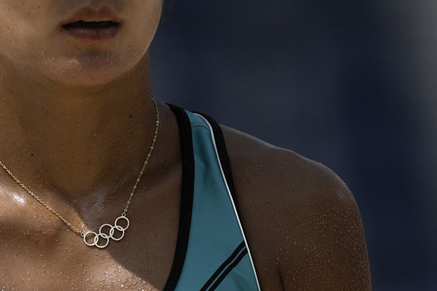  Miki Ishi, of Japan, wears a necklace with the Olympic rings during a women's beach volleyball match against Switzerland at the 2020 Summer Olympics, Wednesday, July 28, 2021, in Tokyo, Japan. (AP Photo/Felipe Dana) 