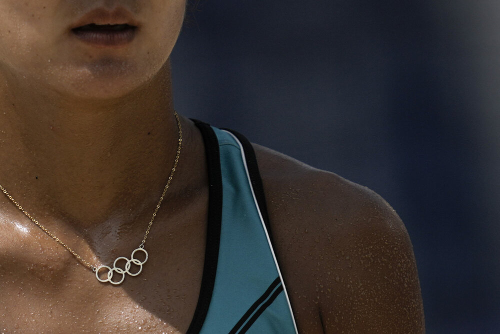  Miki Ishi, of Japan, wears a necklace with the Olympic rings during a women's beach volleyball match against Switzerland at the 2020 Summer Olympics, Wednesday, July 28, 2021, in Tokyo, Japan. (AP Photo/Felipe Dana) 