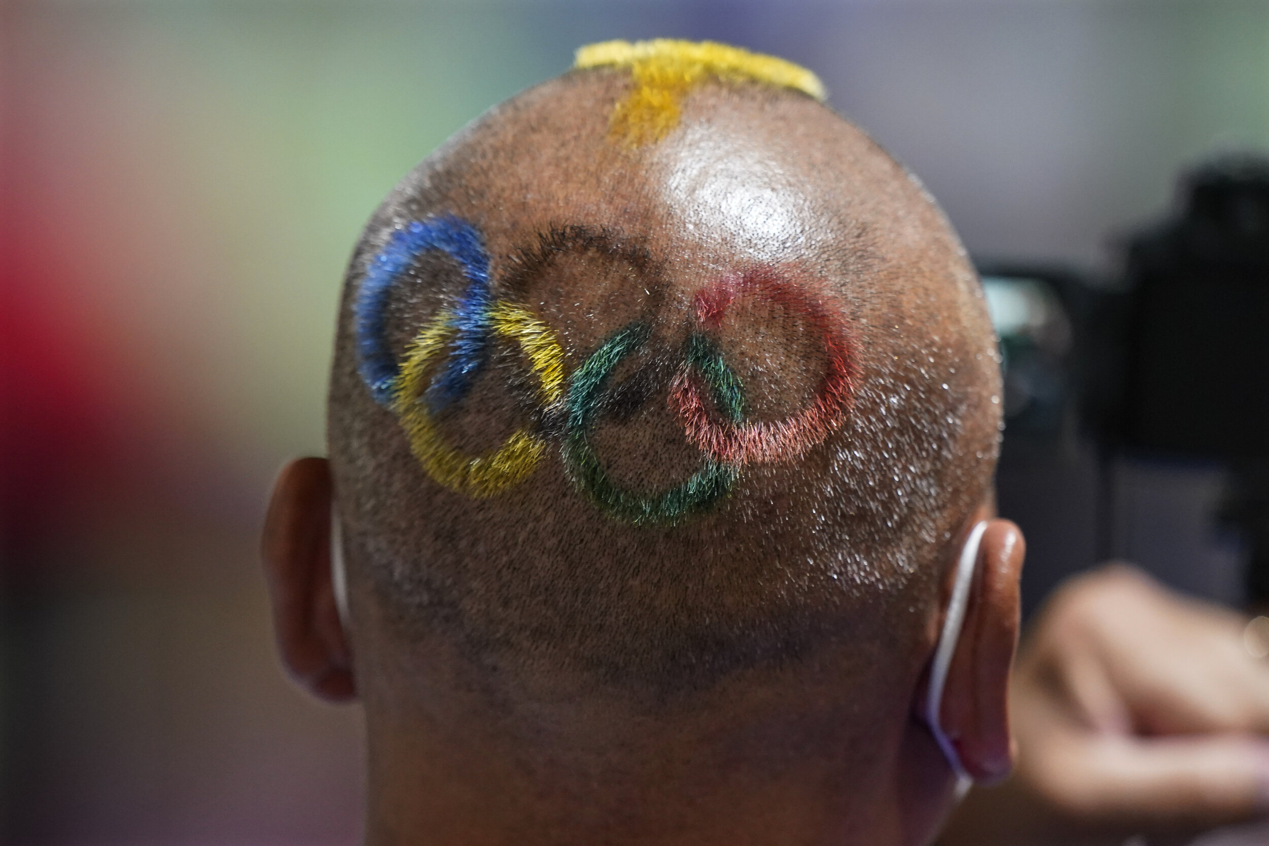  Mongolian coach Undralbat Lkhagva has the Olympic rings cut and dyed into his hair as he watches the women's 10-meter air pistol at the Asaka Shooting Range in the 2020 Summer Olympics, Sunday, July 25, 2021, in Tokyo, Japan. (AP Photo/Alex Brandon)