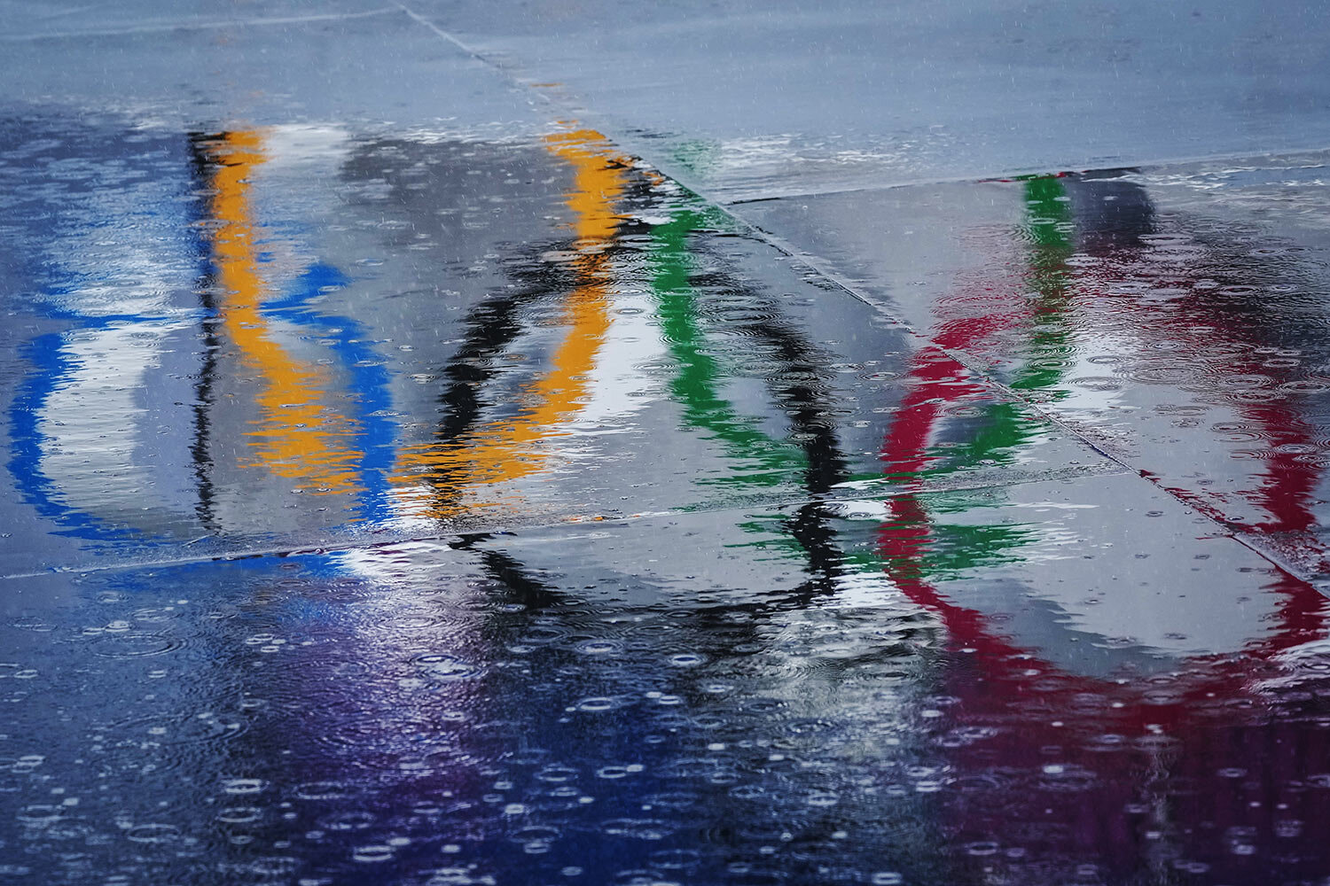  The Olympic rings are seen reflected in water at the BMX Freestyle course after a training session was cancelled due to rain, at the 2020 Summer Olympics, Tuesday, July 27, 2021, in Tokyo, Japan. (AP Photo/Ben Curtis) 